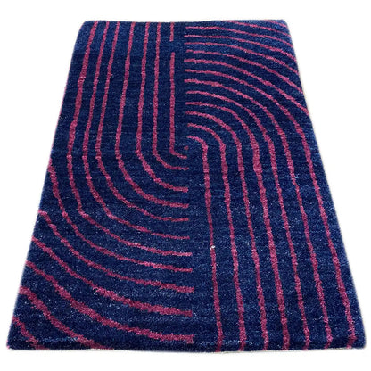 Gabbeh rug with patterned curved lines in dark blue and pink