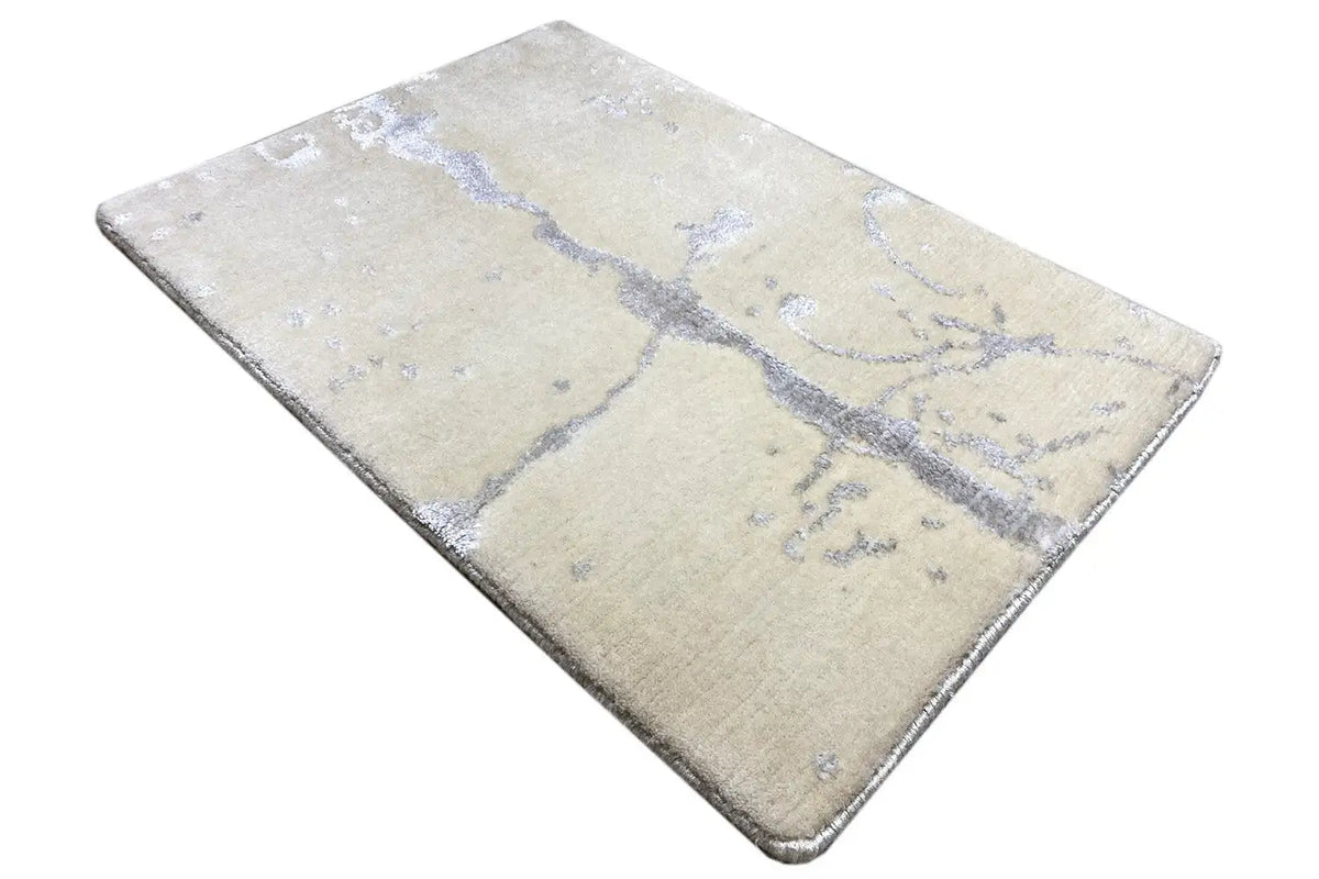 Designer rug 60x40 cm: beige rectangular surface with a blue abstract ornament.