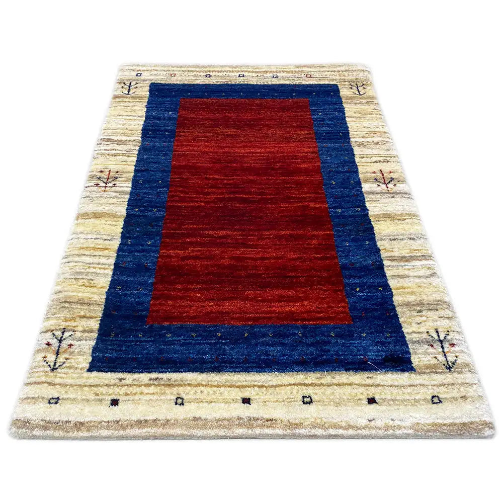 Gabbeh rug with a red center in a blue frame and a cream-colored border with symbols