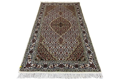 Tabriz rug with medallion pattern, bordered, rectangular, fringes along the edges