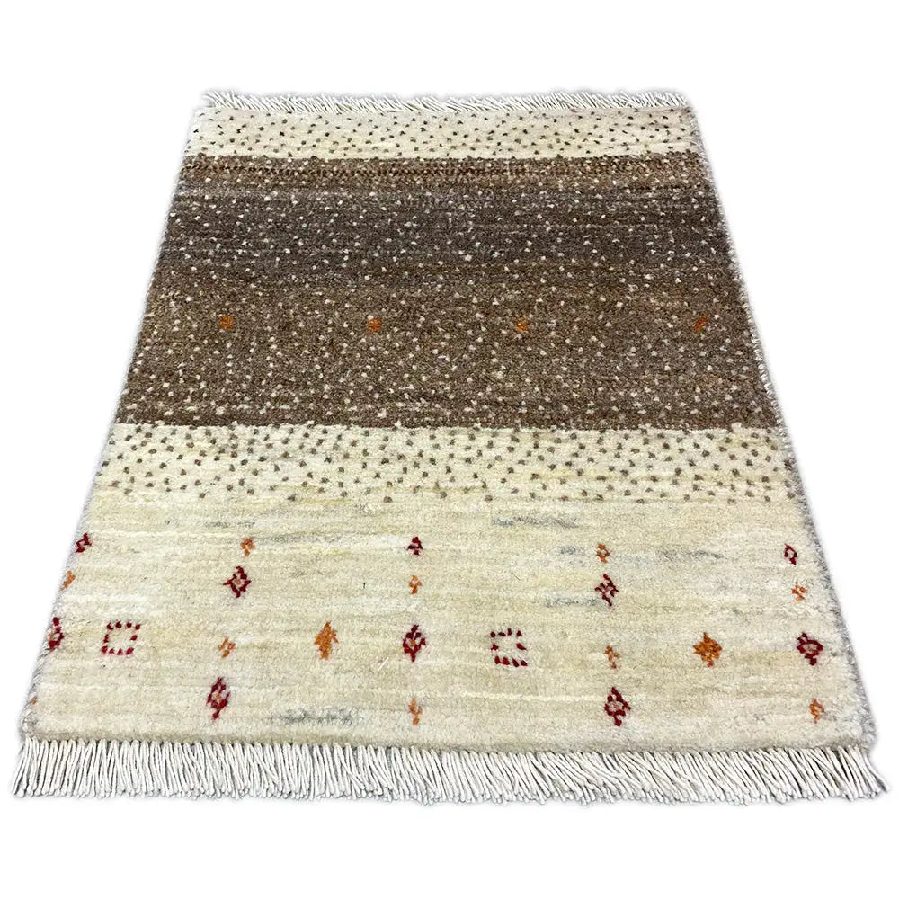 Lori Gabbeh rug with a brown central stripe, colorful ornaments, and fringes