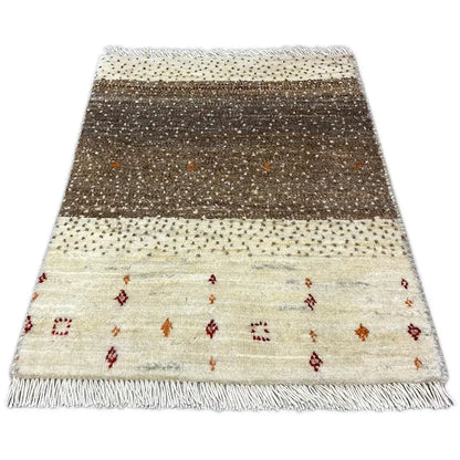 Lori Gabbeh rug with a brown central stripe, colorful ornaments, and fringes