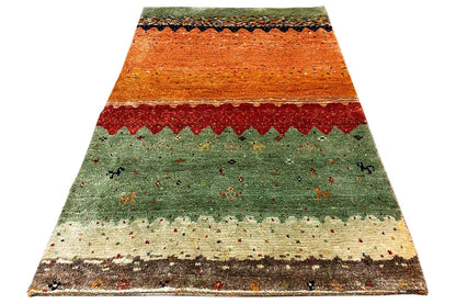 Gabbeh carpet Lori in orange-red-green with zigzag border and fine dot pattern, view.