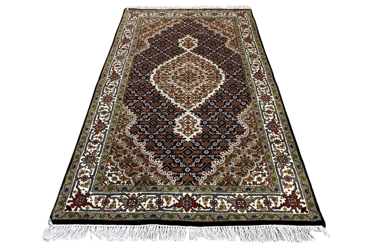 Indo Tabriz rug, brown-black background, central medallion, fringes