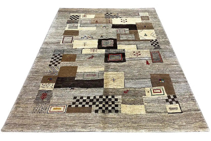 Rectangular Gabbeh rug with an abstract patchwork pattern and diamonds in beige and dark brown