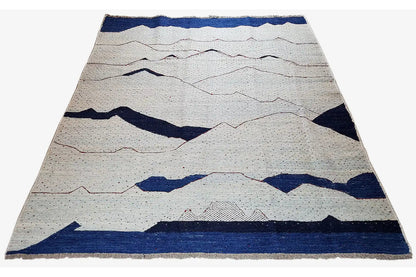 Kilim rug with curved lines and blue accents on a light background