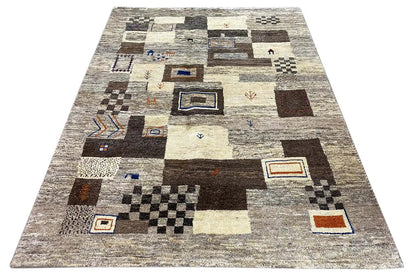Gabbeh rug with abstract patchwork: beige/gray, black-brown blocks, blue and orange accents