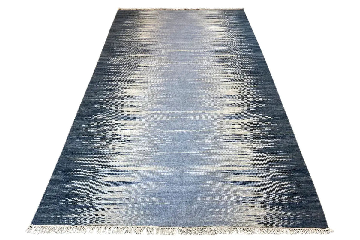 Ombre kilim dhurrie rug in dark blue to light gray, rectangular, with fringes