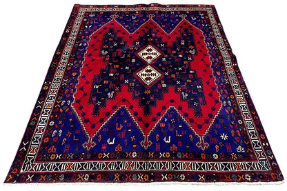 Rug from above: large red pattern in the center on dark blue