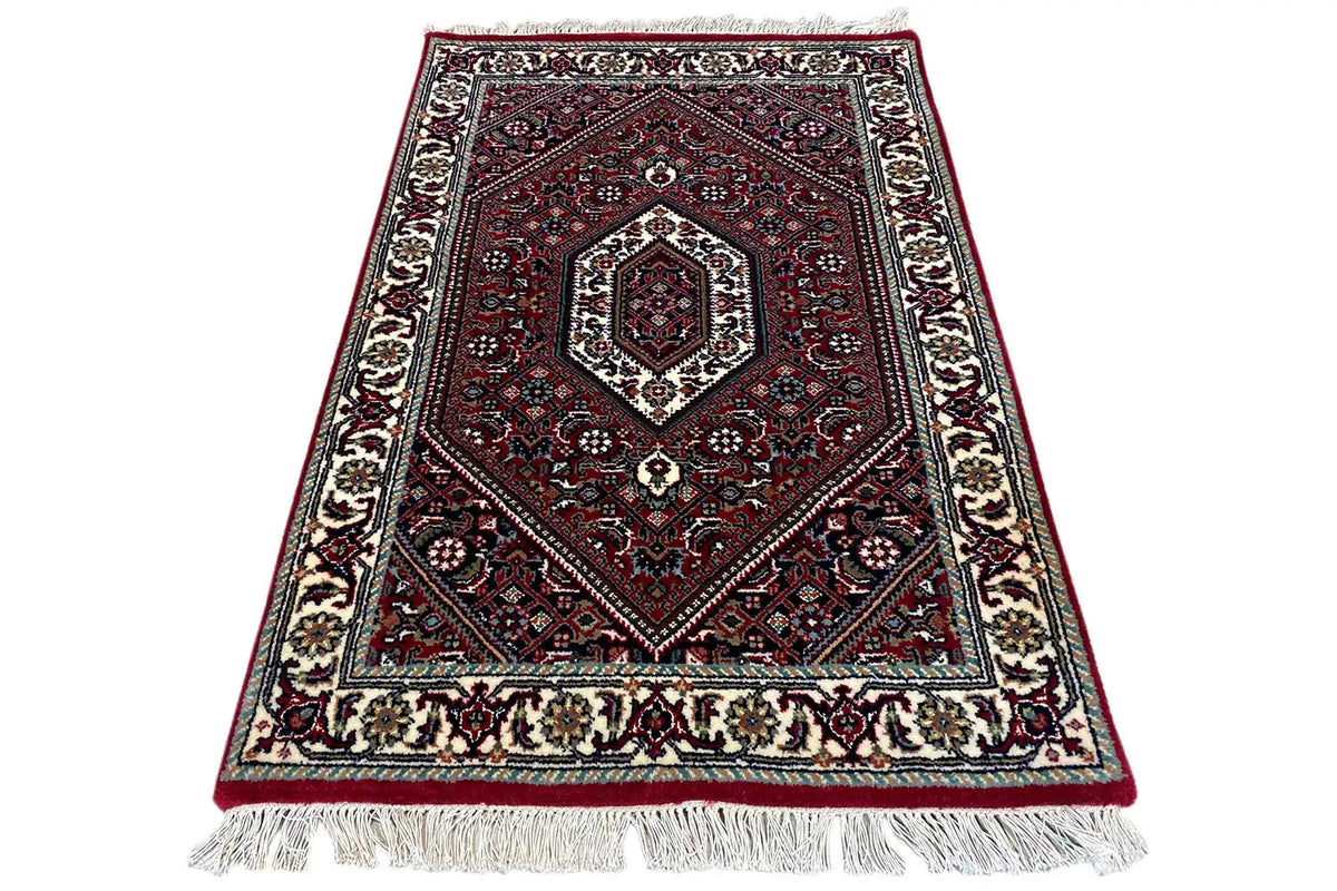 Bidjar rug (93x61 cm) lying flat, red medallion pattern, white fringes