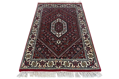 Bidjar rug (93x61 cm) lying flat, red medallion pattern, white fringes