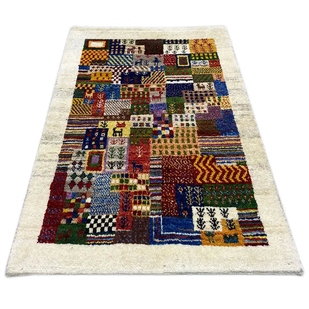 Gabbeh rug with patchwork pattern in blue, red, green, and yellow, size 93x63 cm