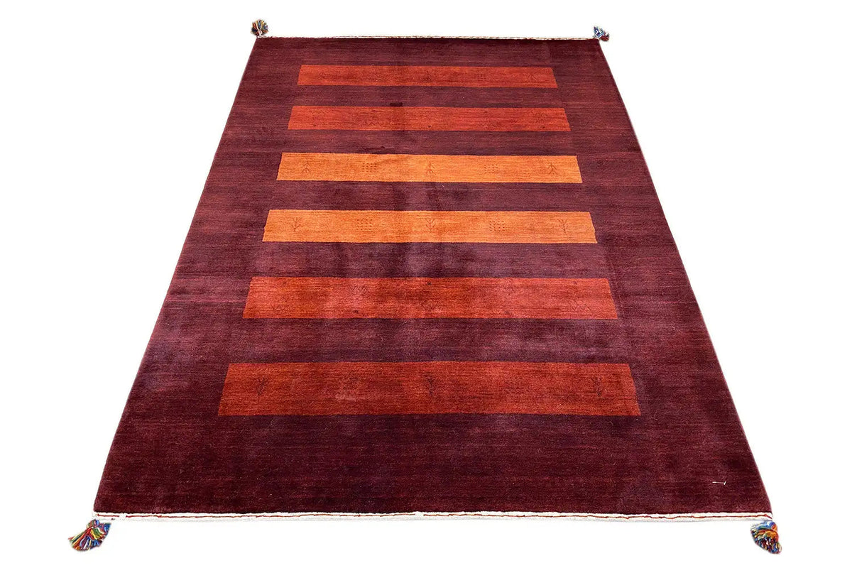 Gabbeh rug in dark red with wide orange horizontal stripes and tassels