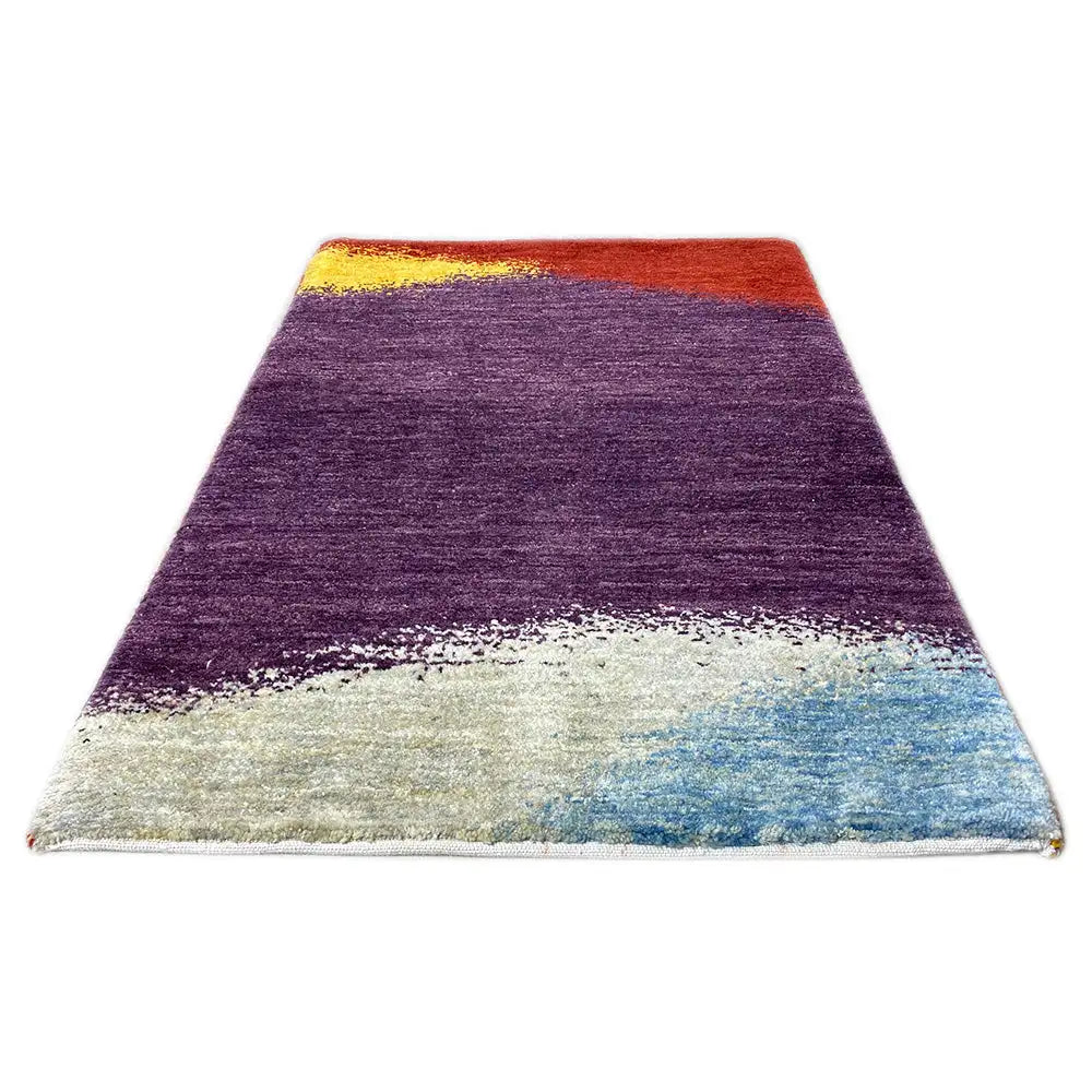 Gabbeh rug with purple center, red border, and blue-white gradient area at the bottom