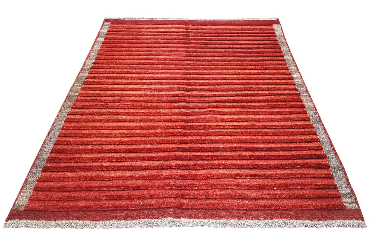 Red rug with a gray border and horizontal stripes, arranged diagonally