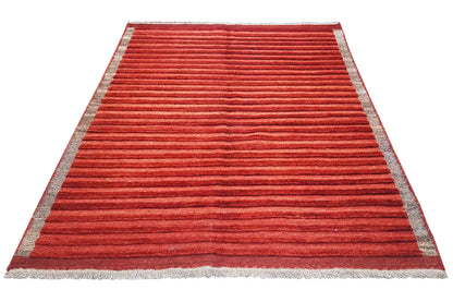 Red rug with a gray border and horizontal stripes, arranged diagonally