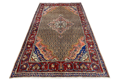 Rectangular oriental rug with a delicate ornamental pattern in brown, red, and blue