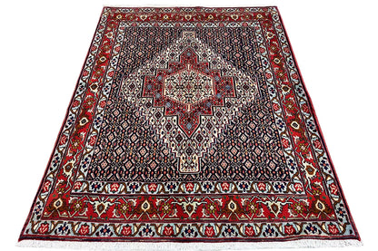 Hamadan rug in trapezoidal view with a central star pattern and red border