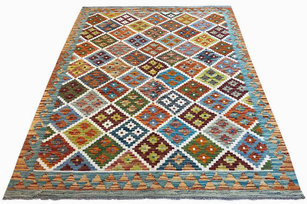 Woven kilim rug with a diamond and square pattern in shades of blue, orange, and green