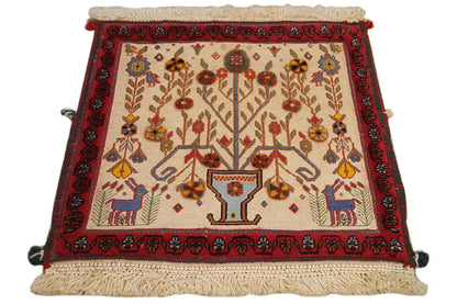 Decorative cushion cover with a red border and central tree motif, edges with fringes