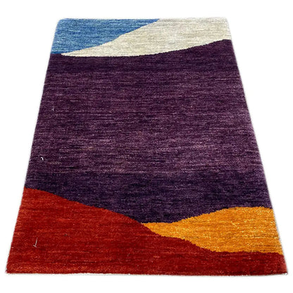 Gabbeh rug in a rectangular format with purple patterned areas, a blue stripe, and orange (90×59 cm)