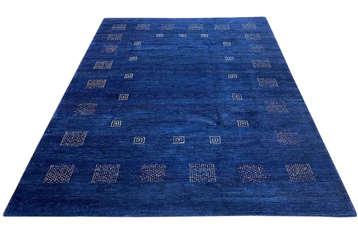 Blue carpet viewed from above with evenly spaced square patterns