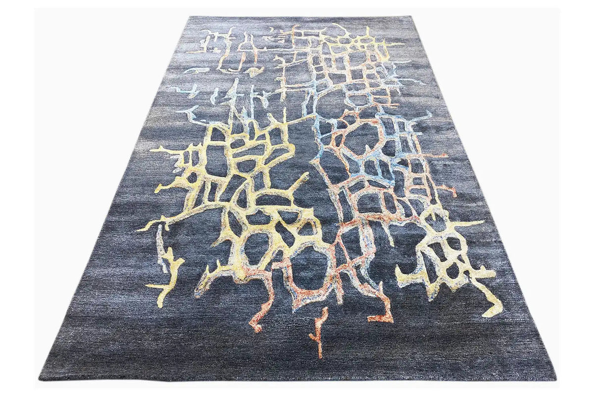 Hand-tufted rug with a trapezoidal cut and yellow-blue spotted pattern
