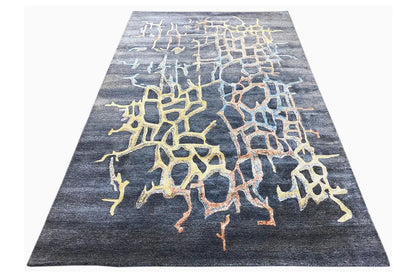 Hand-tufted rug with a trapezoidal cut and yellow-blue spotted pattern