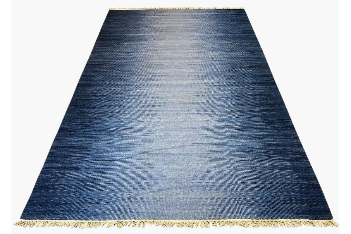 Dark blue kilim rug with a brushed look, gold-colored border and fringes