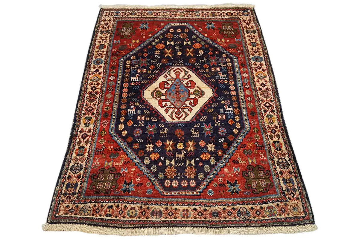 Oriental rug with a red border, blue central medallion, and ornamental border