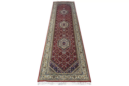 Bidjar runner in red/brown with central medallions, framed by a light ornamental border