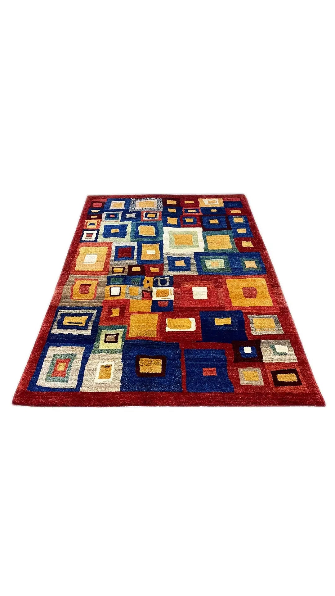 Gabbeh rug laid flat with square color blocks in blue and red