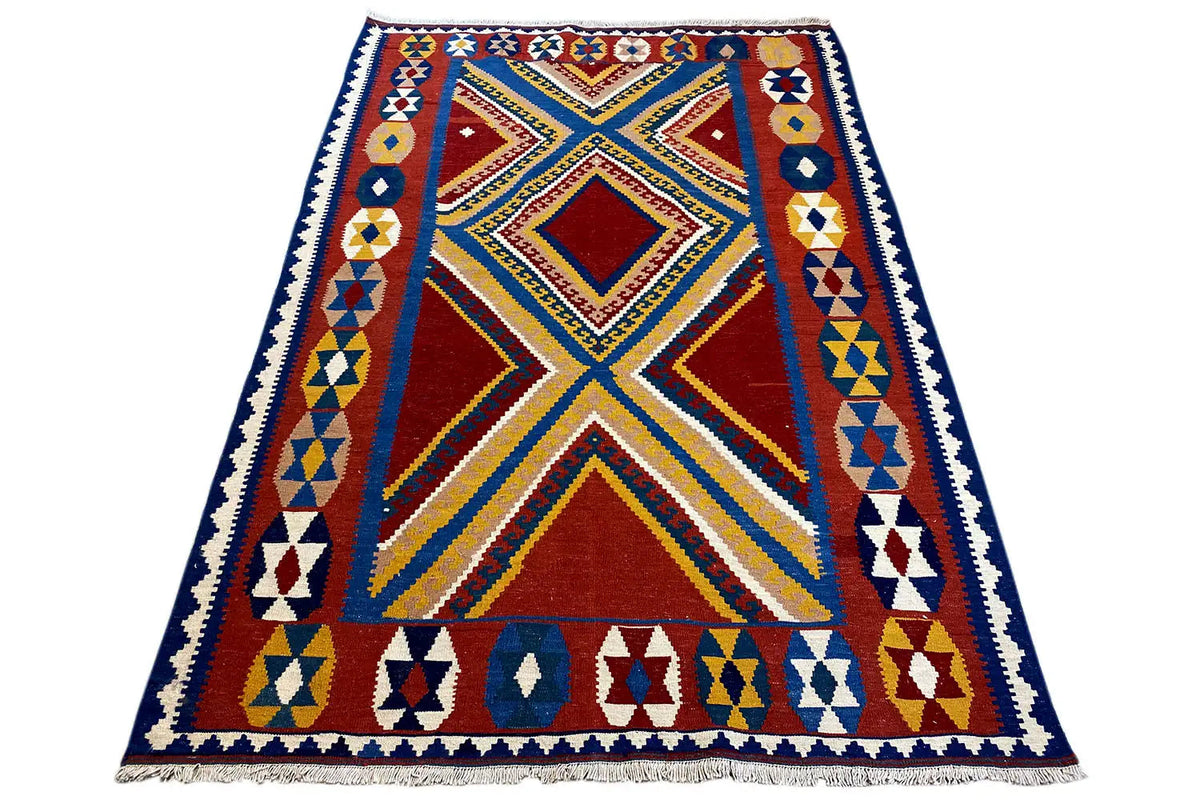 Kilim rug with a large diamond medallion and surrounding border in red, blue, and yellow