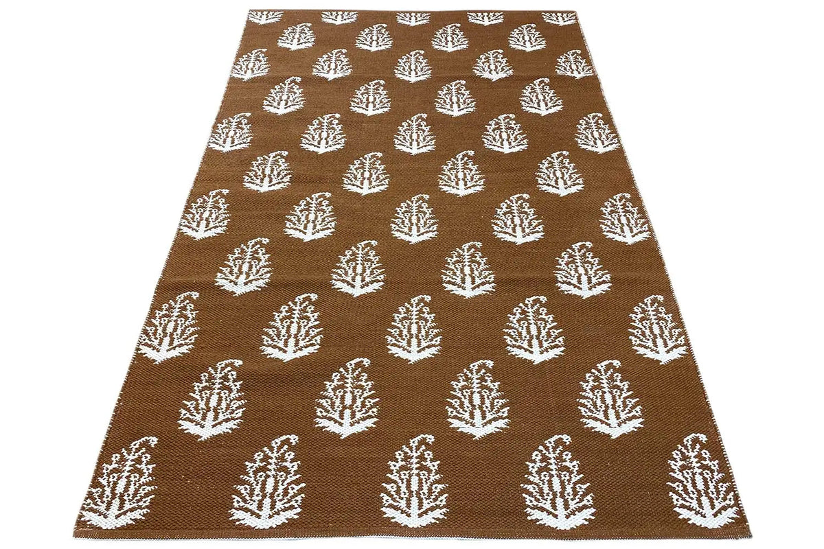 Brown kilim with white tree motifs all over, rectangular rug area