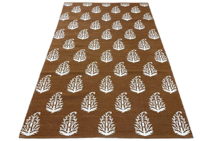 Brown kilim with white tree motifs all over, rectangular rug area
