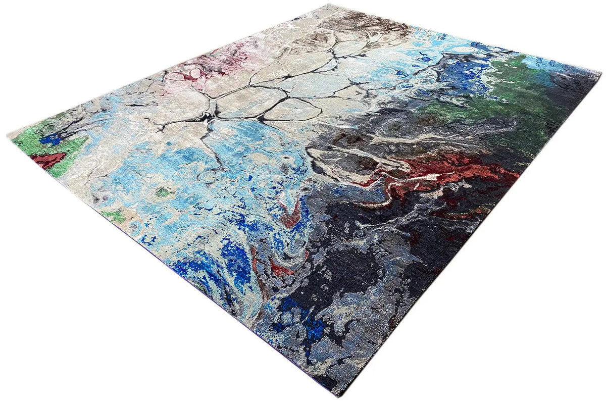 Designer rug in a diagonal composition: abstract lines and patches of color in blue, gray, and red.