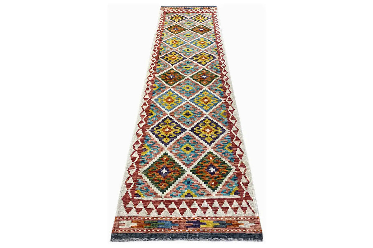 Narrow Kelim runner, geometric pattern in blue, yellow, and red, with fringes