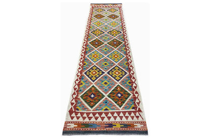 Narrow Kelim runner, geometric pattern in blue, yellow, and red, with fringes