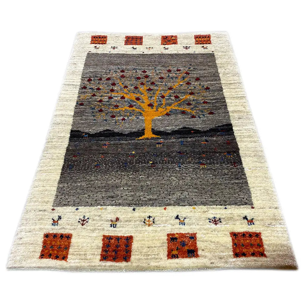 Gabbeh Lori rug: rectangular rug with a dark gray field and a yellow tree