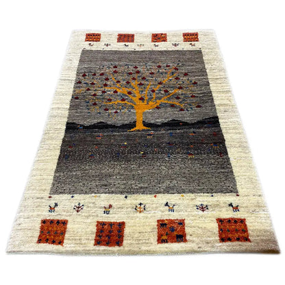 Gabbeh Lori rug: rectangular rug with a dark gray field and a yellow tree