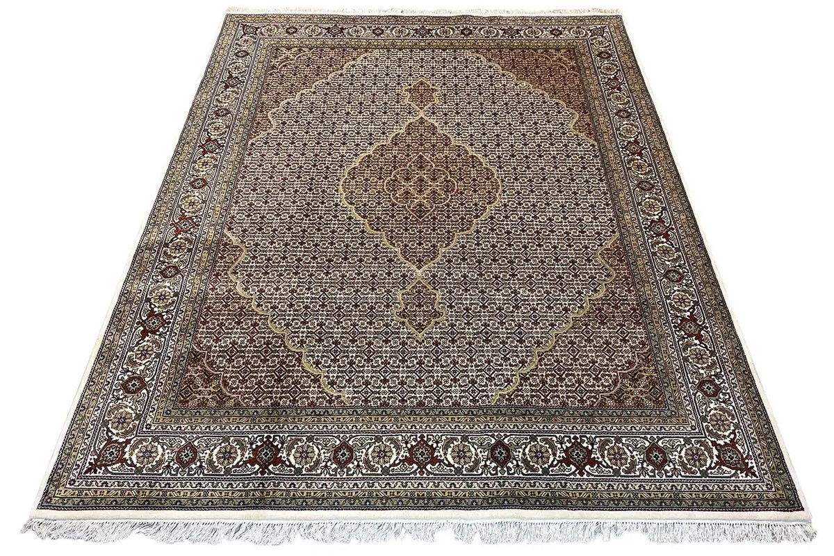 Rug with central ornamental medallion, dark border, and short fringes, beige-brown
