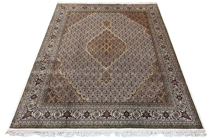 Rug with central ornamental medallion, dark border, and short fringes, beige-brown
