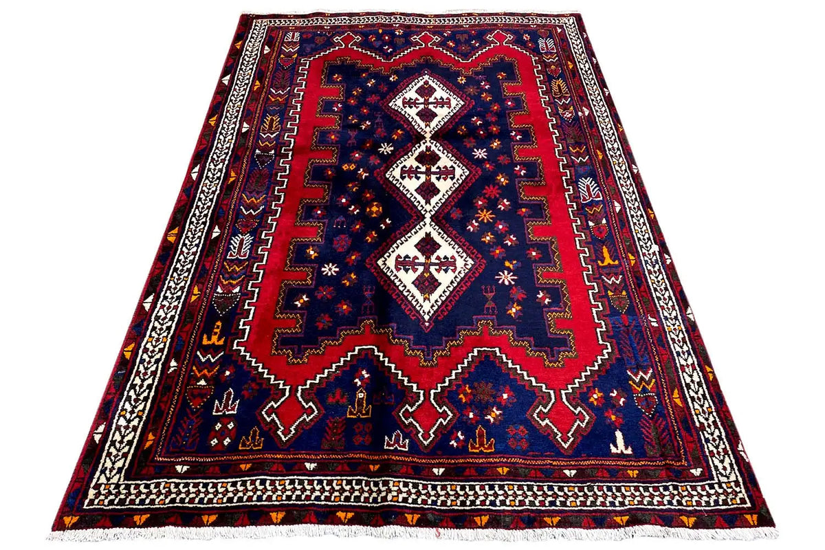 Triangularly spread rug with a blue background, red border, and medallions