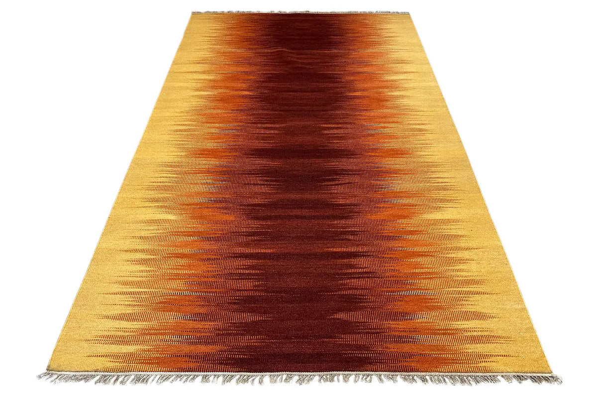 Kilim rug with a yellow-brown gradient and fringes, spread out from above