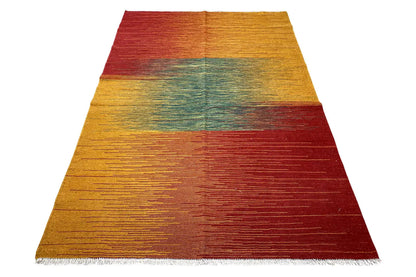 Kilim rug in honey yellow, teal, and burgundy with clean lines and bound edges