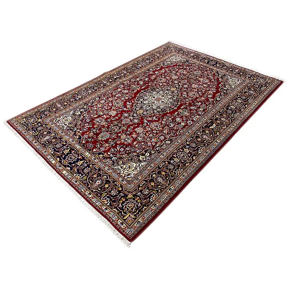 Keshan rug, rectangular, burgundy with a dark medallion and finely decorated borders.