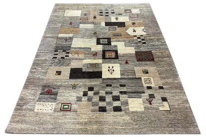 Gabbeh rug 204x150 cm with an all-over geometric pattern in gray and cream.