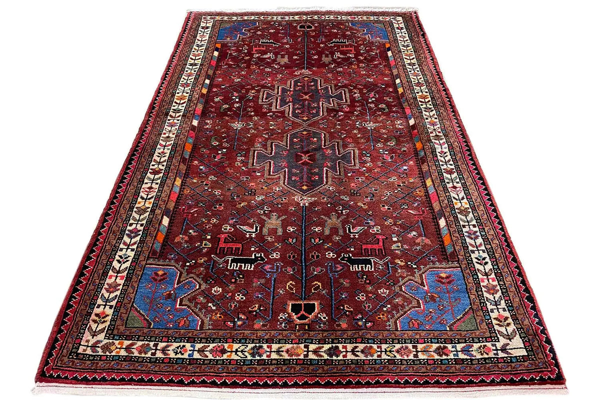 Rectangular Hamadan rug with a red ground, blue-red ornaments, and decorative border