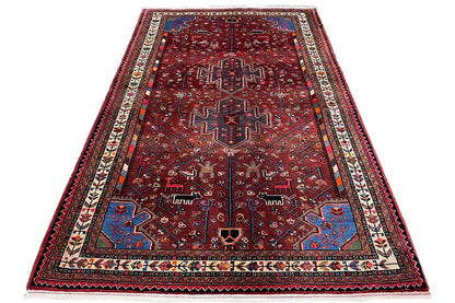 Rectangular Hamadan rug with a red ground, blue-red ornaments, and decorative border