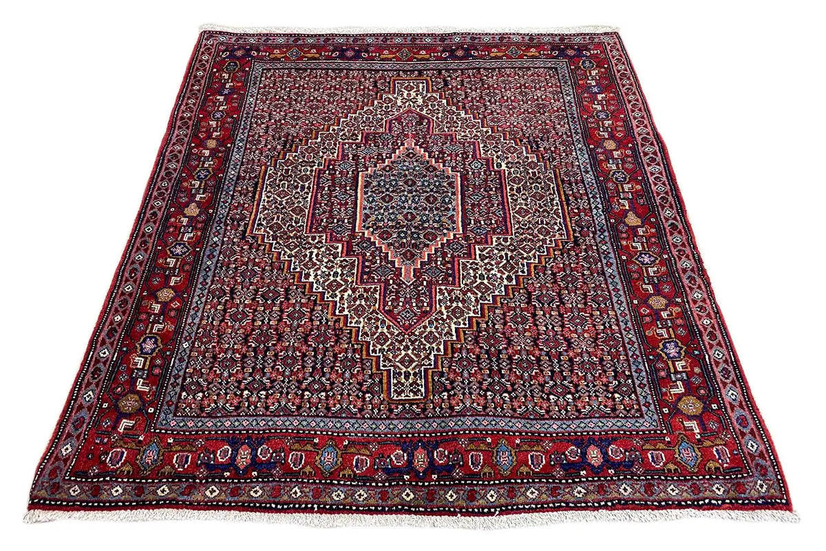 Flat carpet with a square medallion, red patterned field, and wide border